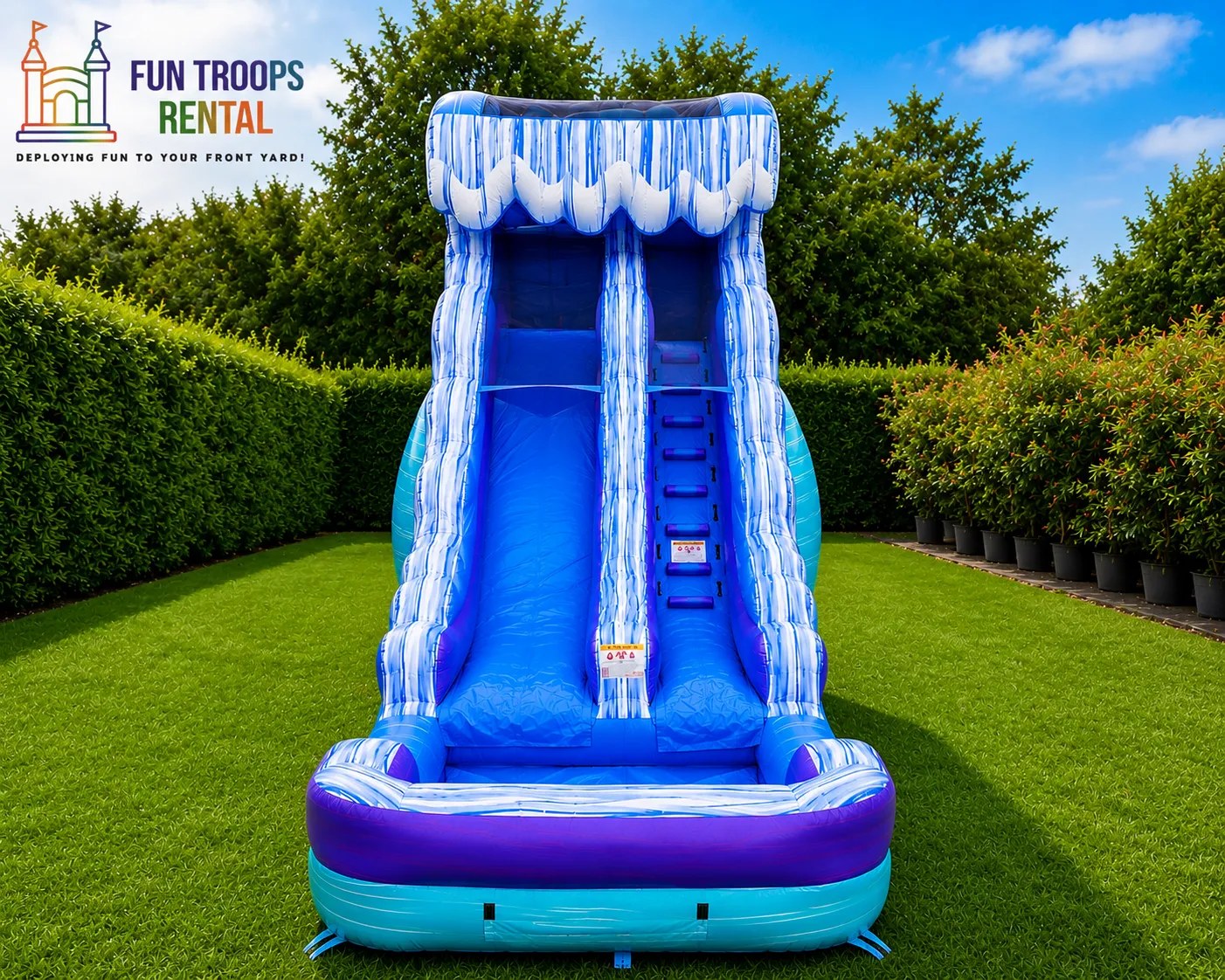 Blue and purple ocean wave themed double-lane water slide with splash pool
